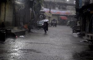 A woman gets drenched in heavy rain while heading home without any protective gear as downpour lashes the twin cities.