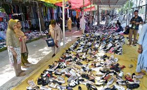 A vendor displays and sells a variety of school bags, luggage bags and other bags at the weekly bazaar in I-9/4.