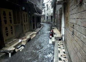 A woman gets drenched in heavy rain while heading home without any protective gear as downpour lashes the twin cities.