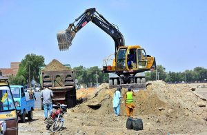 Labourers are busy construction work of new Wahduwah Road with heavy machine during development work in the city.