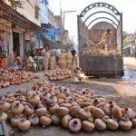 Labourers are busy unloading clay pots from a delivery truck in pottery market at Daulat Gate