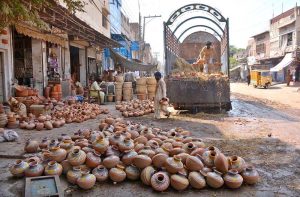 Labourers are busy unloading clay pots from a delivery truck in pottery market at Daulat Gate