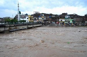 A view of Nullah Leh flowing at a dangerously high level following heavy monsoon rains, as the swollen waterway poses a serious threat to residential areas and settlements built along its banks in the Federal capital.