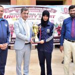 Vice Chancellor of Government College University Faisalabad (GCUF) Prof. Dr. Rauf-i-Azam presents a trophy to the female winner of the 10-kilometre race during International Sports Day at the university