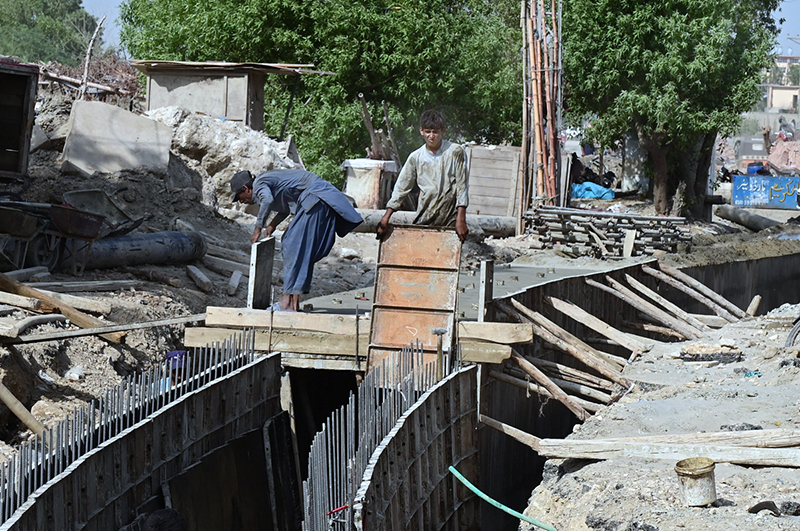 Labourers are busy in constructing work of sewerage Nala as part of development work on Autobahn Road