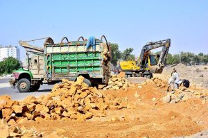 Labourers busy with construction work on Wadhu Wah Road as development work continues in the city.