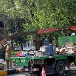 Technicians use a crane-mounted platform to install a Safe City camera on a pole at Aabpara Chowk in the Federal Capital