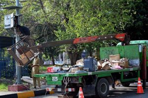 Technicians use a crane-mounted platform to install a Safe City camera on a pole at Aabpara Chowk in the Federal Capital