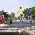 Children enjoy jumping on a trampoline at Tewana Park
