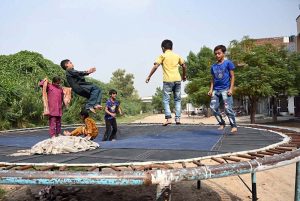 Children enjoy jumping on a trampoline at Tewana Park