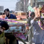 Labourers are busy unloading luggage from a handcart in market at Raja Bazaar
