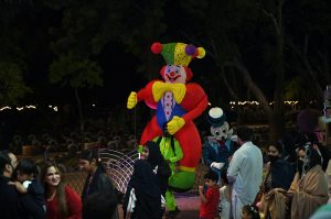 A group of students pose with a mascot at the amusement section of Lake View Park