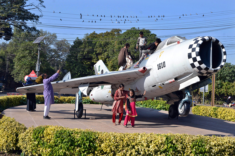 Children enjoying weekend by visiting a model plane installed by Pakistan Air Force at China Chowk