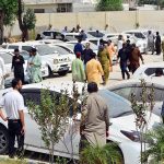 People are viewing non-paid custom vehicles before purchasing them during a non-paid custom vehicles auction ceremony by the Customs Department at the Customs Office