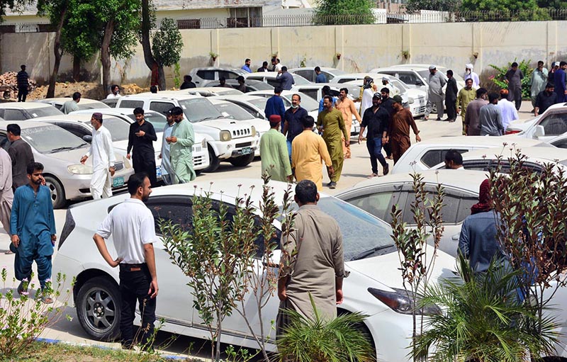 People are viewing non-paid custom vehicles before purchasing them during a non-paid custom vehicles auction ceremony by the Customs Department at the Customs Office