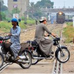 Motorcyclists crossing the railway track near the railway station while a train is approaching can lead to accidents and raises serious safety concerns