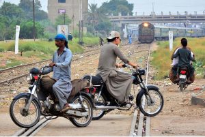 Motorcyclists crossing the railway track near the railway station while a train is approaching can lead to accidents and raises serious safety concerns