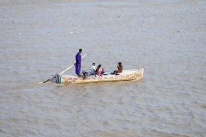 A large number of boats are parked on the bank of the Indus River at Al-Manzar picnic point