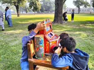 Children enjoying weekend by visiting a model plane installed by Pakistan Air Force at China Chowk