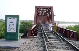 Youngster are running on the Mehran Railway Bridge as the train approaches near Husenabad