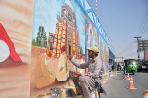 An artist paints a vibrant mural depicting Multan’s rich cultural heritage on the wall of a flyover at Chungi No. 9, as part of ongoing beautification efforts, adding colour and cultural charm to the cityscape.