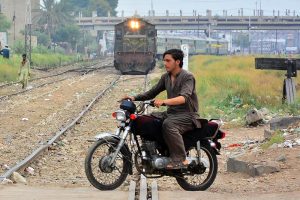 Motorcyclists crossing the railway track near the railway station while a train is approaching can lead to accidents and raises serious safety concerns