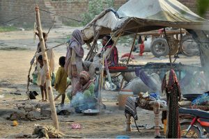 Laborers work in grueling conditions at a local brick kiln, mixing clay and shaping raw bricks to earn their daily livelihood