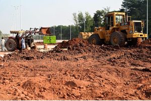 Heavy machinery work alongside labourers at the Park Road Underpass project site, as construction work on the much-anticipated infrastructure project nears completion in the Federal Capital