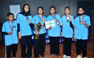 A group photo of Net ball team of Shah Latif Girls collage with wining trophy during closing ceremony of 5th PNF net ball cup 2026 at Hyderabad club
