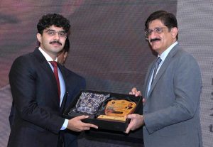 Sindh Chief Minister Syed Murad Ali Shah presents a shield to a successful scholar during the felicitation ceremony organised by the College Education Department at CM House, Karachi, Sindh.