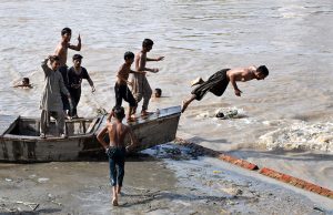 Youngsters diving in Rice Canal to get relief from scorching hot and humid weather.