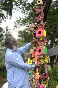 Garden decoration items are displayed at a park road to attract gardening enthusiasts in the federal capital.