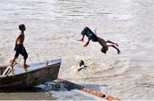 Youngsters diving in Rice Canal to get relief from scorching hot and humid weather.
