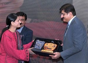 Sindh Chief Minister Syed Murad Ali Shah presents a shield to a successful scholar during the felicitation ceremony organised by the College Education Department at CM House, Karachi, Sindh.