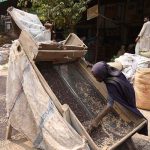 A labourer cleans mustard seeds at the Grain Market