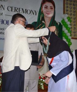 Chairman BISE Faisalabad Dr. Rana Binyamin presents certificates and medals to position-holder students at a ceremony announcing the Intermediate Examination 2026 results.