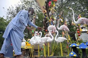 Garden decoration items are displayed at a park road to attract gardening enthusiasts in the federal capital.