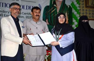 Chairman BISE Faisalabad Dr. Rana Binyamin presents certificates and medals to position-holder students at a ceremony announcing the Intermediate Examination 2026 results.