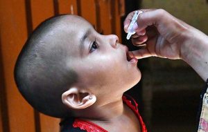 A lady health worker administers polio drops to a child during an anti-polio campaign aimed at a polio-free Pakistan.