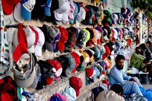 A roadside vendor waits for customers while displaying second-hand toys to attract passersby at his stall in the provincial capital