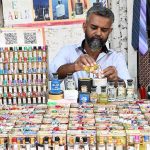 A vendor sells ittar (perfume) by the roadside in old Anarkali