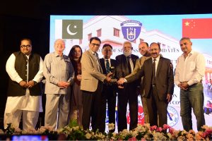 Federal Minister for Education and Professional Training Dr Khalid Maqbool Siddiqui being presented with a shield at a ceremony marking the departure of the first batch of IOD diploma students for China
