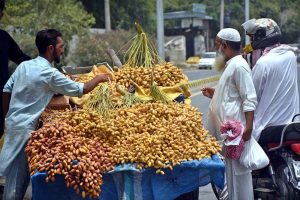A vendor displays and sells dates at a roadside stall to attract customers