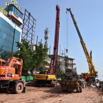 Heavy construction machinery including excavators and cranes are deployed at the service road construction site along the Expressway, as development work continues to improve the road infrastructure in the Federal Capital