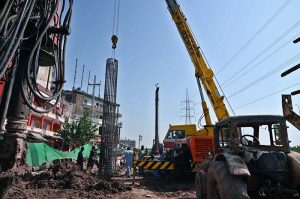 Heavy construction machinery including excavators and cranes are deployed at the service road construction site along the Expressway, as development work continues to improve the road infrastructure in the Federal Capital
