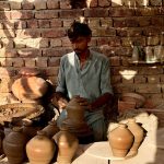 A worker is busy preparing clay-made items at his workplace in Kumhar Pura