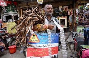 A vendor sells traditional tooth-cleaning sticks and dandasa at Urdu Bazaar.