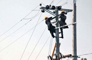 WAPDA staffers are busy installing new electric wires on poles