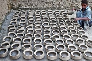 A potter makes clay cooking pots and other earthenware at his workplace in the provincial capital.