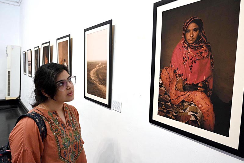 A visitor shows her keen interest in the photographs displayed at the exhibition 'The Too-Young Monsoon Brides' by French photographer Isabeau de Rouffignac at the Zahoor-ul-Akhlaq Art Gallery. The exhibition was organized by Alliance Française Lahore in collaboration with the French Embassy in Pakistan and the National College of Arts